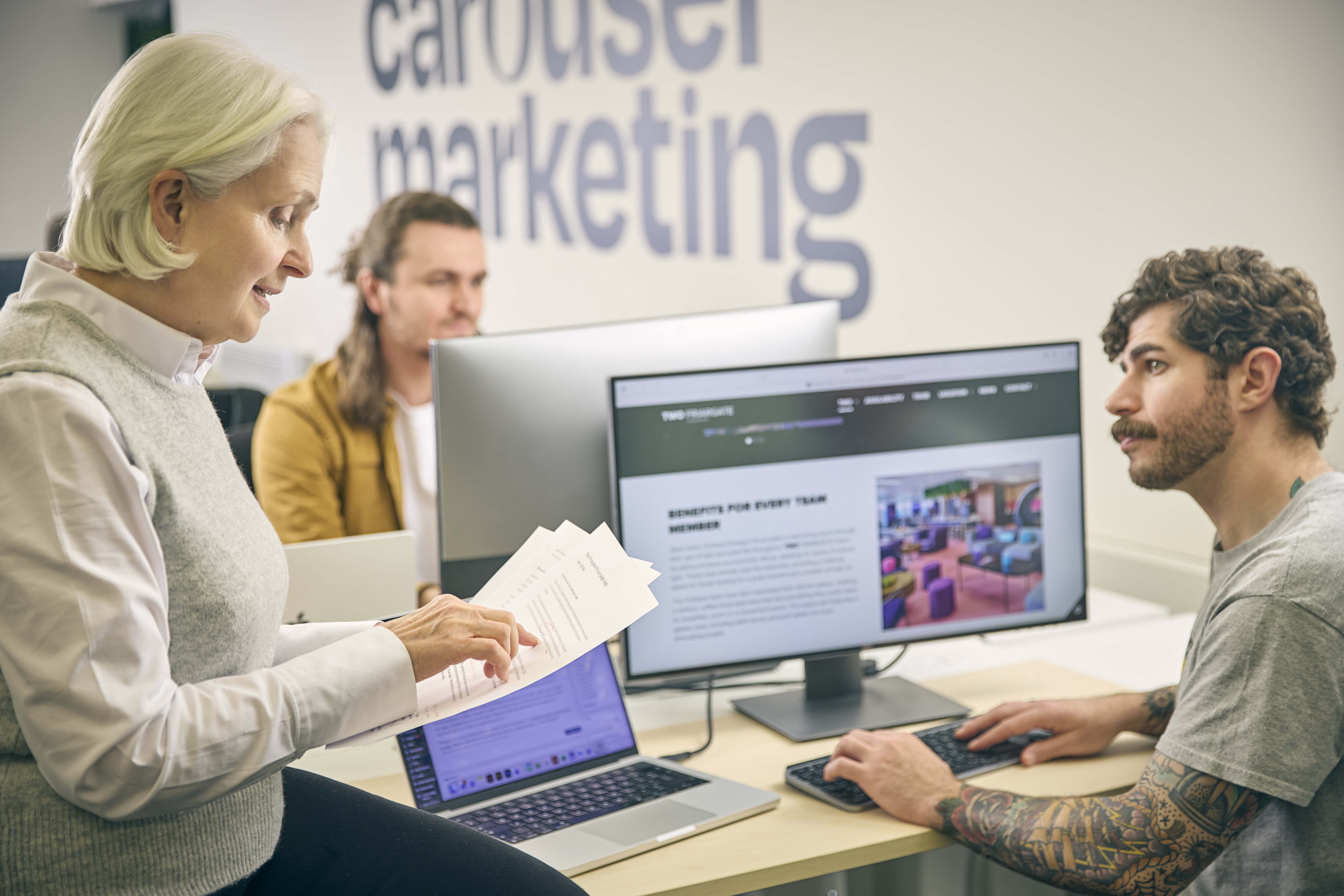 Beverley Dunn and Ben Camilleri discuss a project at Carousel Marketing